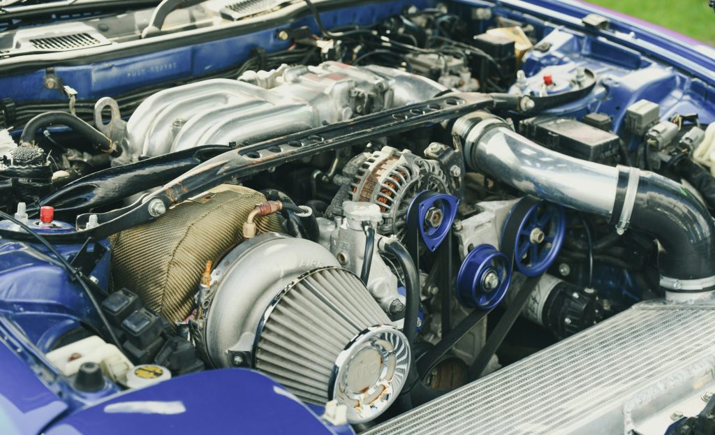 Close-up of a modified car engine with turbocharger.
