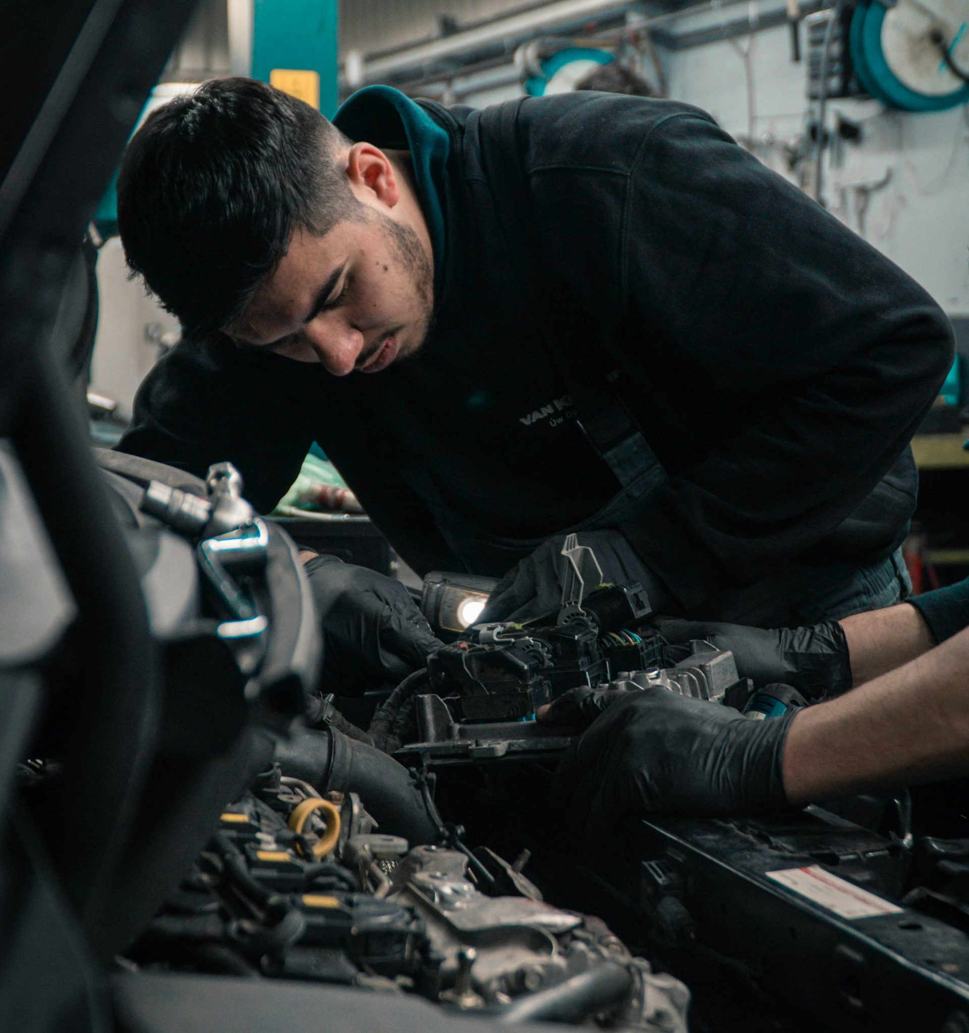 man in black jacket and blue denim jeans riding motorcycle